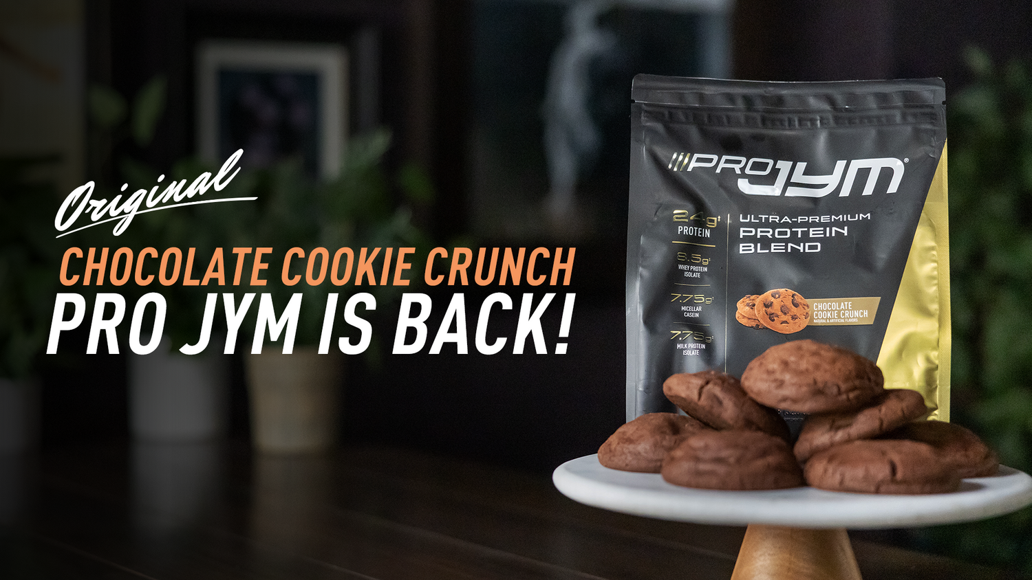 Black Pro JYM Chocolate Cookie Crunch protein bag with nutrition facts next to stacked chocolate cookies, announcing its return.