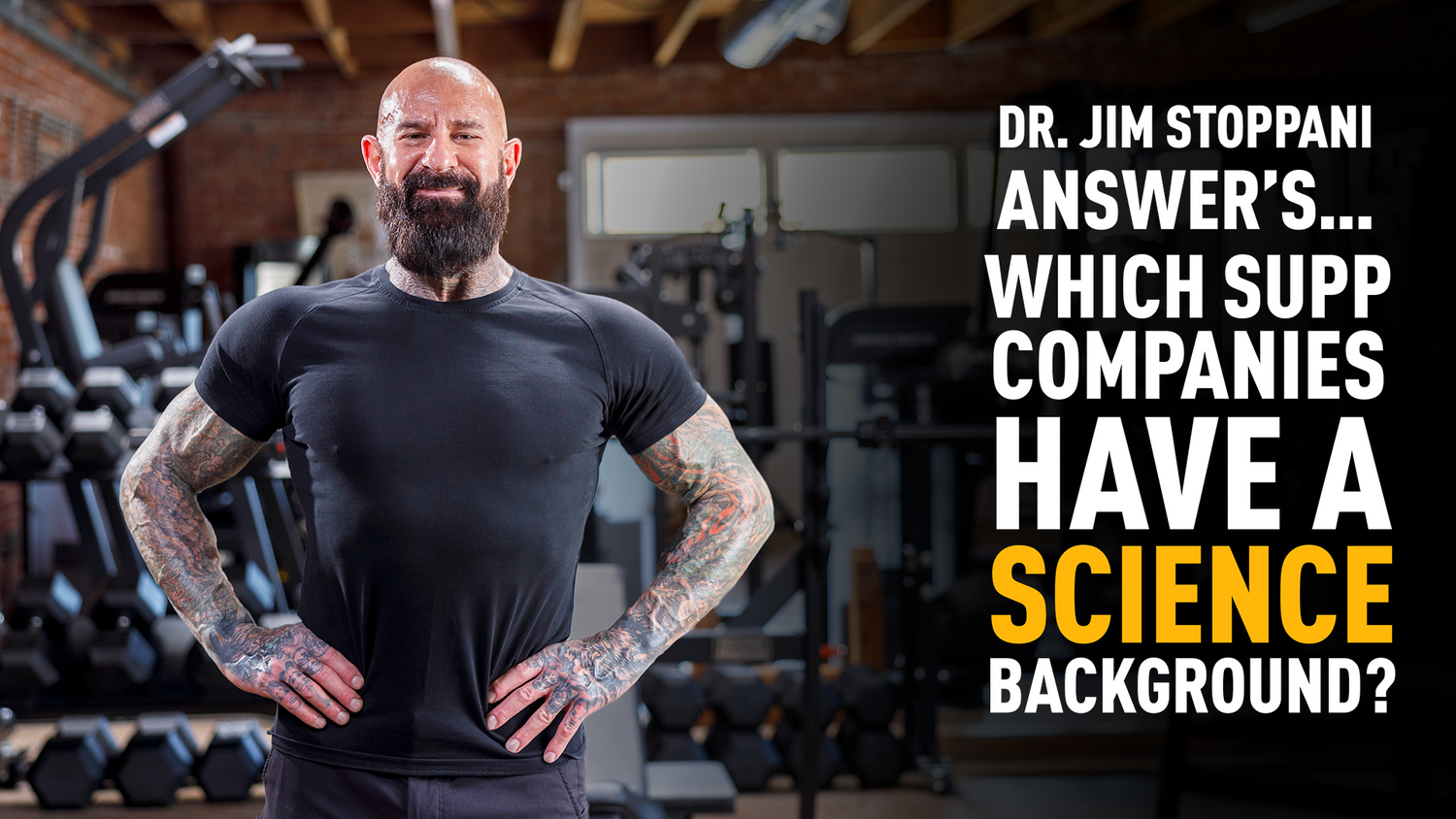 Tattooed Dr. Jim Stoppani poses in gym with dumbbells and rack behind him for article on supplement company science credentials.