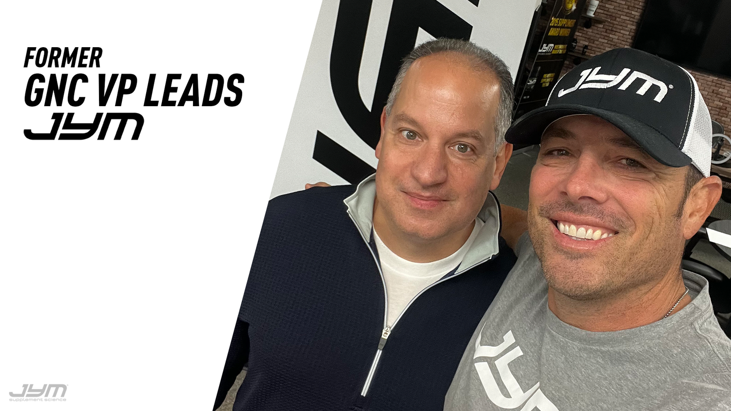 Jim Stoppani in JYM cap and tee poses with Kevin Maloberti beside "Former GNC VP Leads JYM" headline graphic.