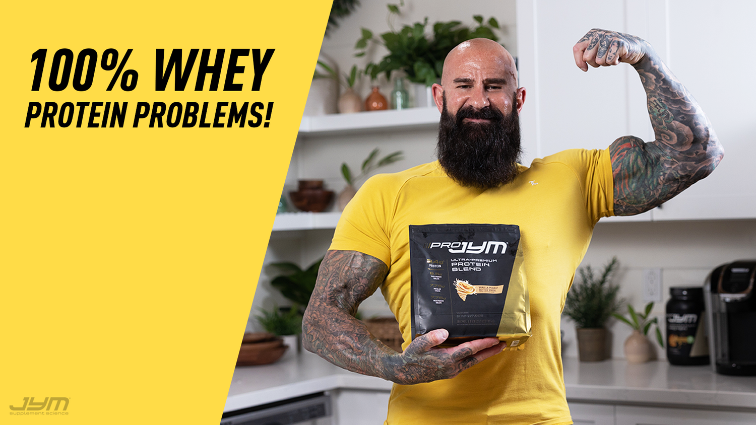 Bearded man in yellow shirt flexing bicep and holding Pro JYM protein pouch in kitchen, "100% Whey Protein Problems!" text.