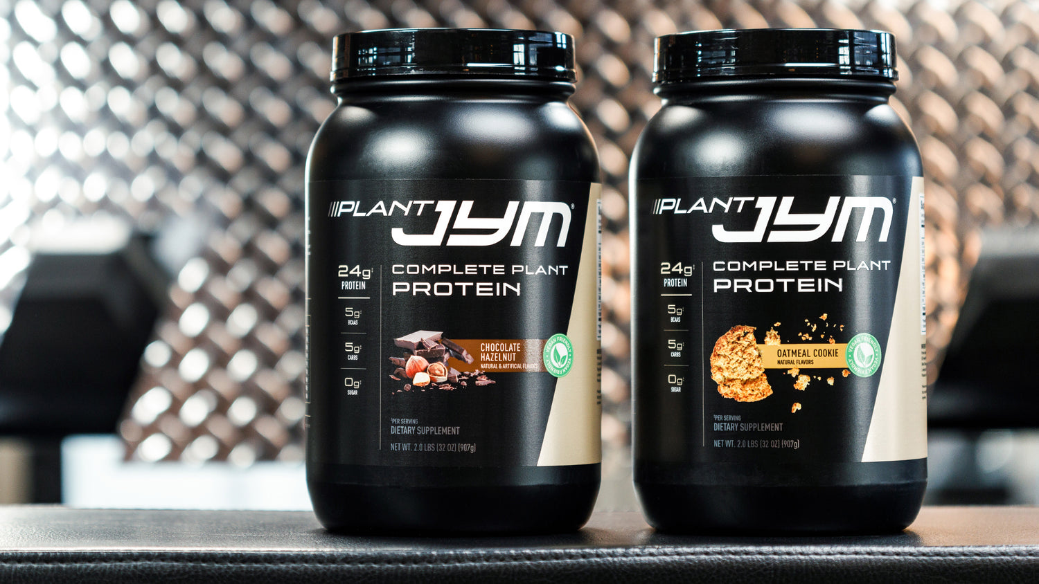 Chocolate Hazelnut and Oatmeal Cookie Plant JYM protein jars displayed together, black tubs with 24g protein and vegan-friendly labels.