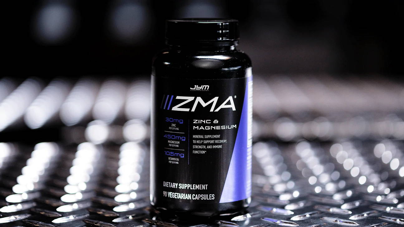 Black JYM ZMA bottle centered on steel diamond-plate, front label facing camera, Rest Easy and Recover Fully with ZMA JYM article.