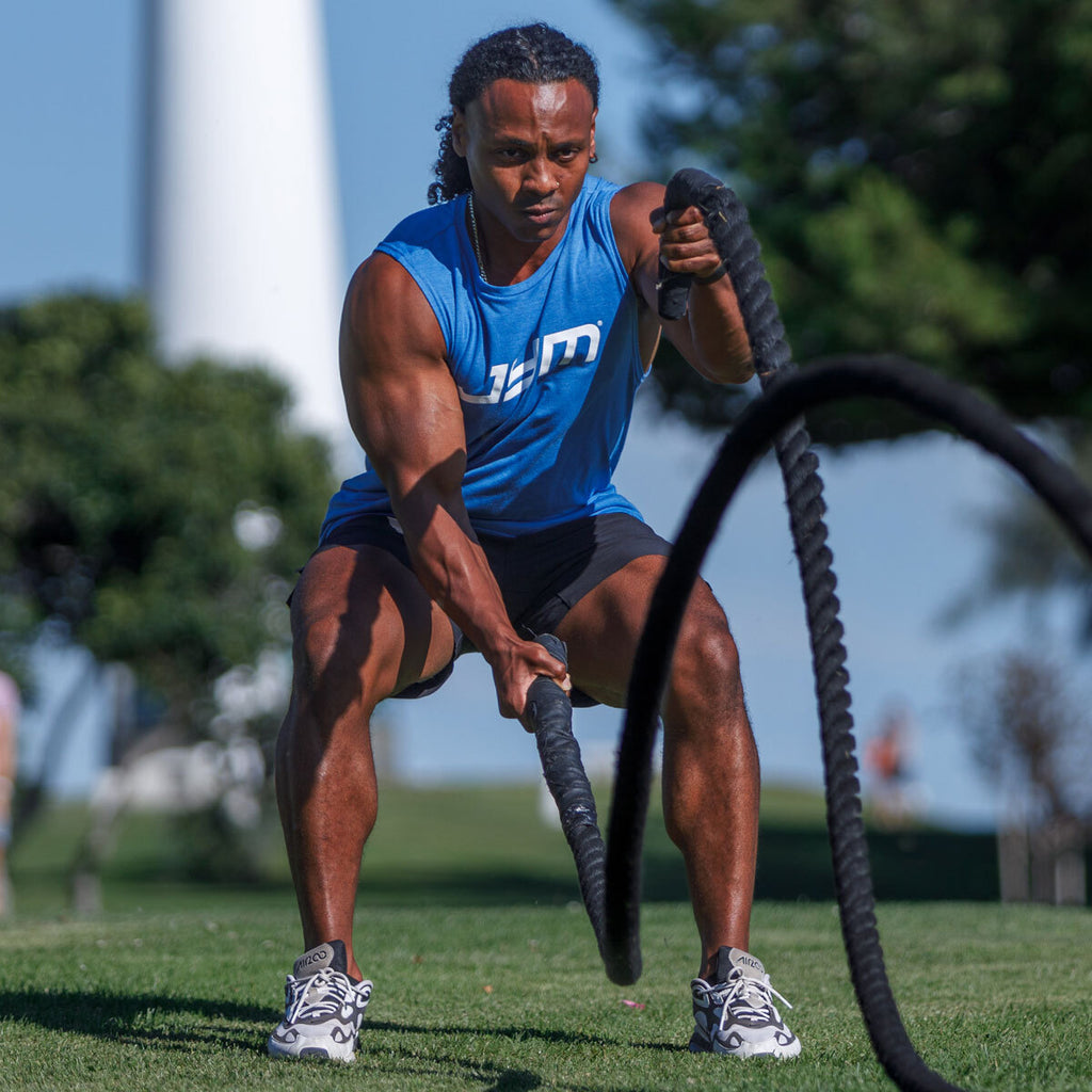 JYM Athlete performing a battle rope exercise